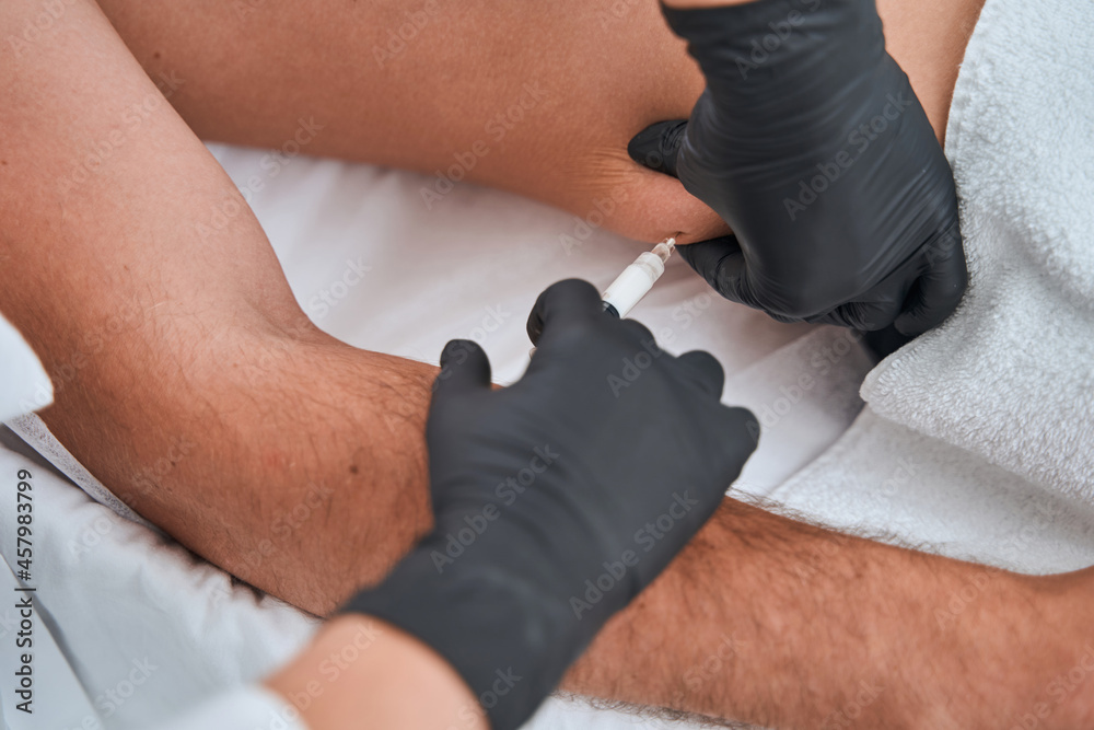 Female doctor carrying out a body sculpting procedure