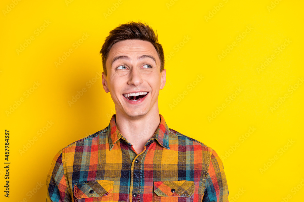 Portrait of attractive curious cheerful brown-haired guy laughing thinking copy space isolated over bright yellow color background Portrait of attractive curious cheerful brown-haired guy laughing thinking copy space isolated over bright yellow color background