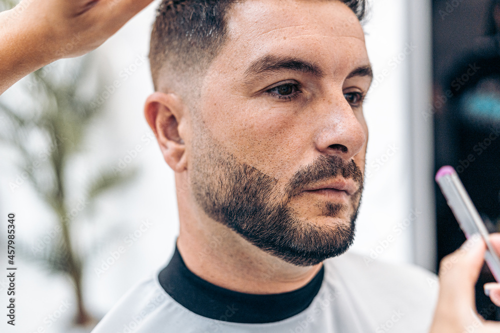 Fototapeta premium Man wit relaxed expression while being shaved with a manual razor