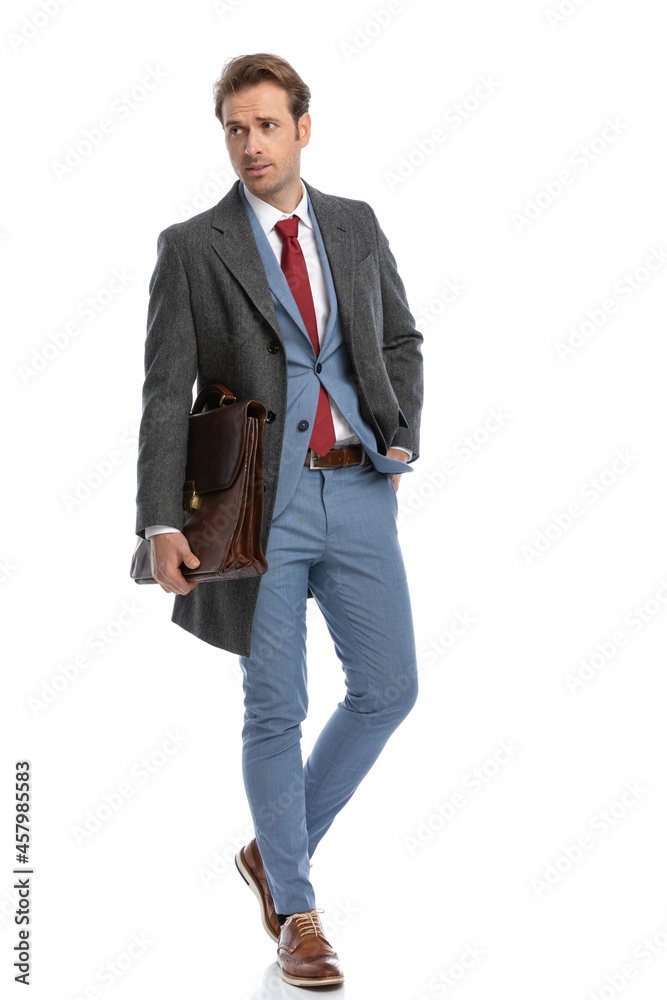 sexy young businessman with suitcase holding hand in pocket sexy young businessman with suitcase holding hand in pocket