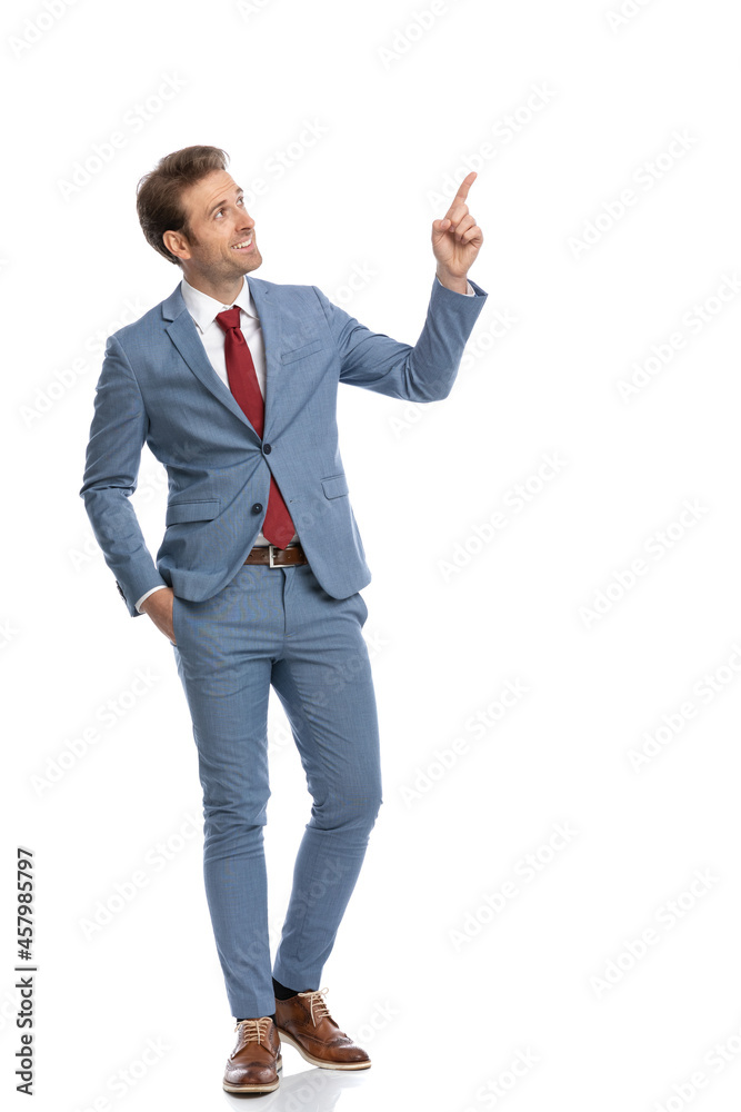elegant businessman looking to side and pointing finger up and side elegant businessman looking to side and pointing finger up and side