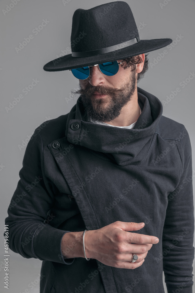 young casual man with tough look is wearing sunglasses