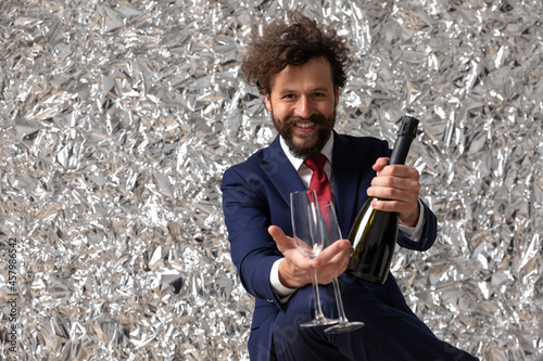 happy businessman raising a toast with two glasses photo