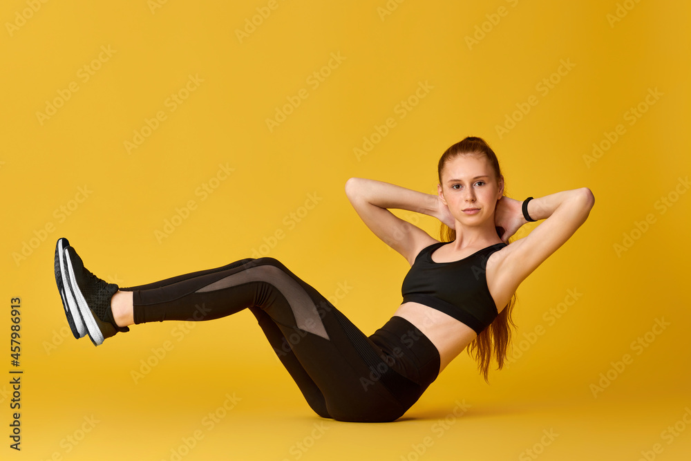 girl in black sportswear doing v-ups abs workout girl in black sportswear doing v-ups abs workout