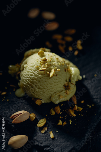 Delicious pistachio gelato scoop on dark surface