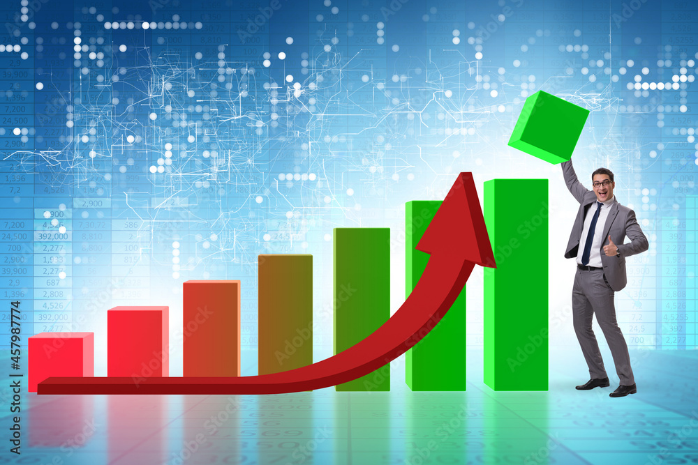 Businessman supporting economic growth on chart Businessman supporting economic growth on chart
