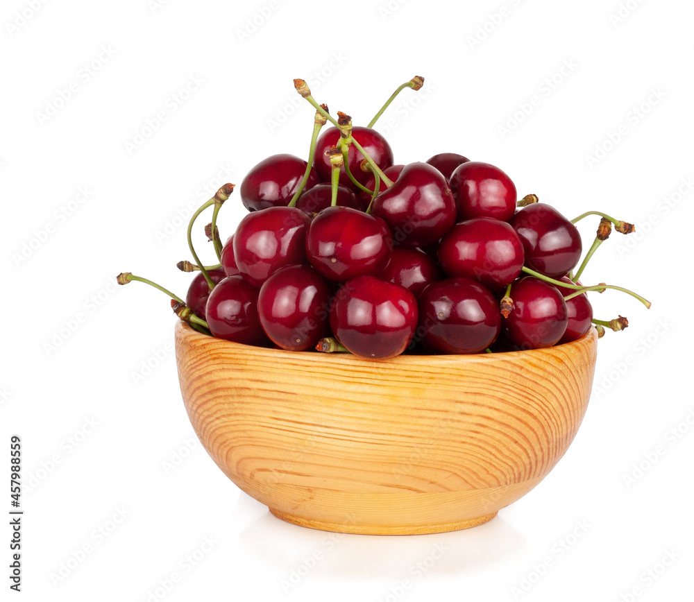 Sweet cherry in wooden cup isolated on a white background Sweet cherry in wooden cup isolated on a white background