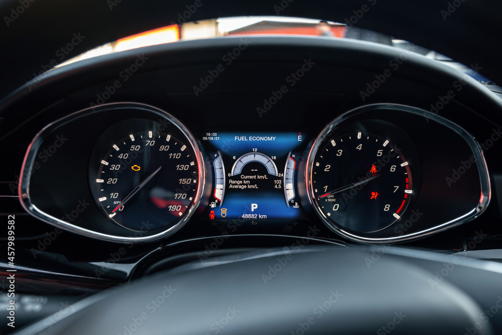 Night time dashboard of modern car. Screen display of car status warning light on dashboard panel symbols which show the fault indicators. OBD Indicator, Seat belt reminder and front airbag indicator
