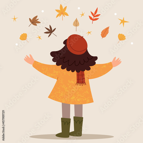 The girl in a red beret throws up autumn leaves. Autumn mood. Childhood. Happy girl.
