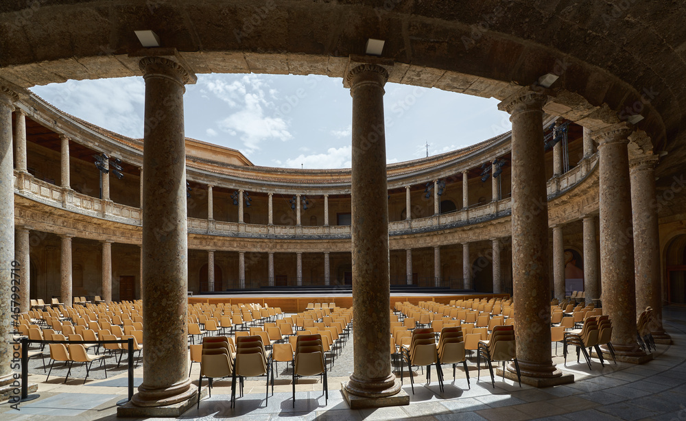 Fototapeta premium Indoor outdoor patio with empty chairs looking out onto a stage