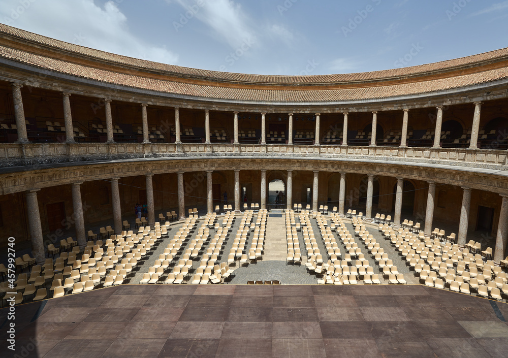Stage with chairs in the round courtyard of a Muslim palace with columns in the open air