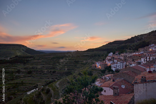 Colorful sunset in a valley with the village to one side