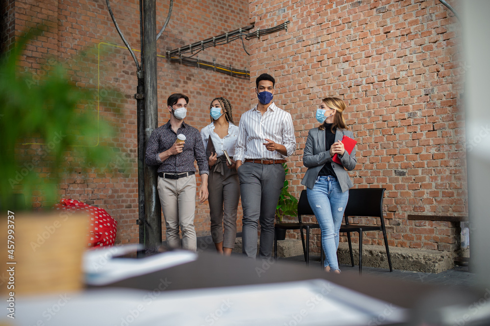 Group of businesspeople feeling joyful in office, cooperation and coronavirus concept. Group of businesspeople feeling joyful in office, cooperation and coronavirus concept.