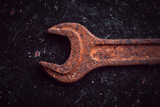 Vintage wrenches covered with rust on a dark background
