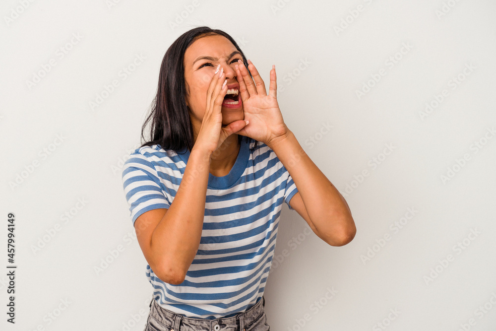 Young latin woman isolated on white background shouting excited to front. Young latin woman isolated on white background shouting excited to front.