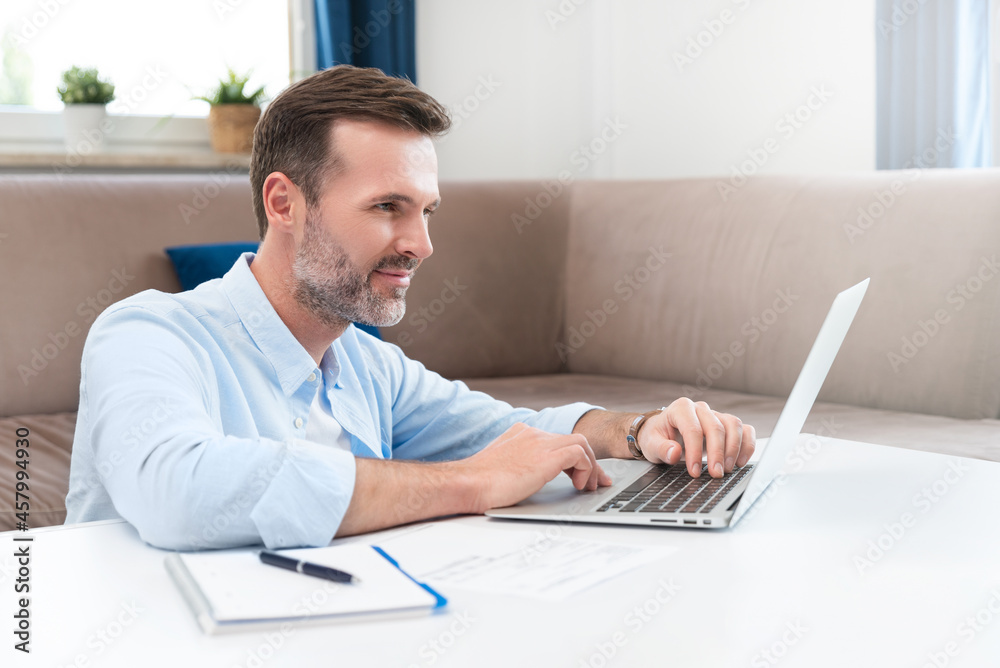 Man working with laptop at home Man working with laptop at home