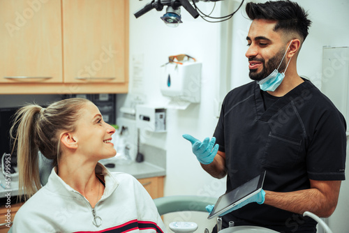 Canvas Print Caucasian female teen arriving for monthly dental check up with male dentist