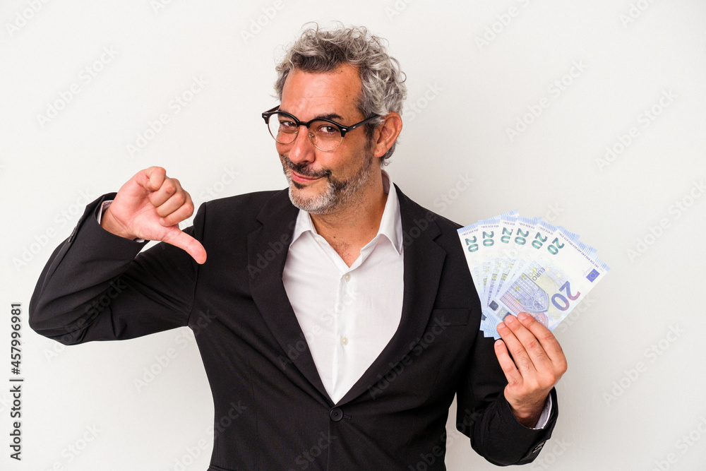 Middle age business man holding bills isolated on blue background feels proud and self confident, example to follow. Middle age business man holding bills isolated on blue background feels proud and self confident, example to follow.