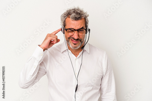 Middle age telemarketer caucasian man isolated on white background covering ears with hands.