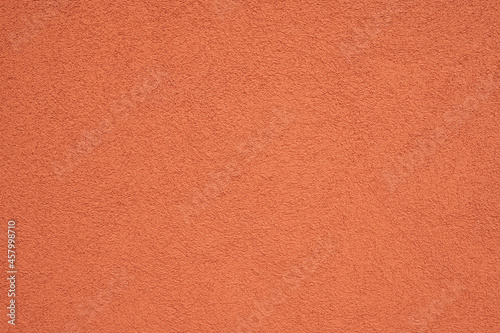 red colored concrete wall background texture with soft lighting