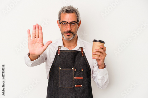 Middle age store clerk holding a take away coffee isolated on white background  standing with outstretched hand showing stop sign, preventing you.