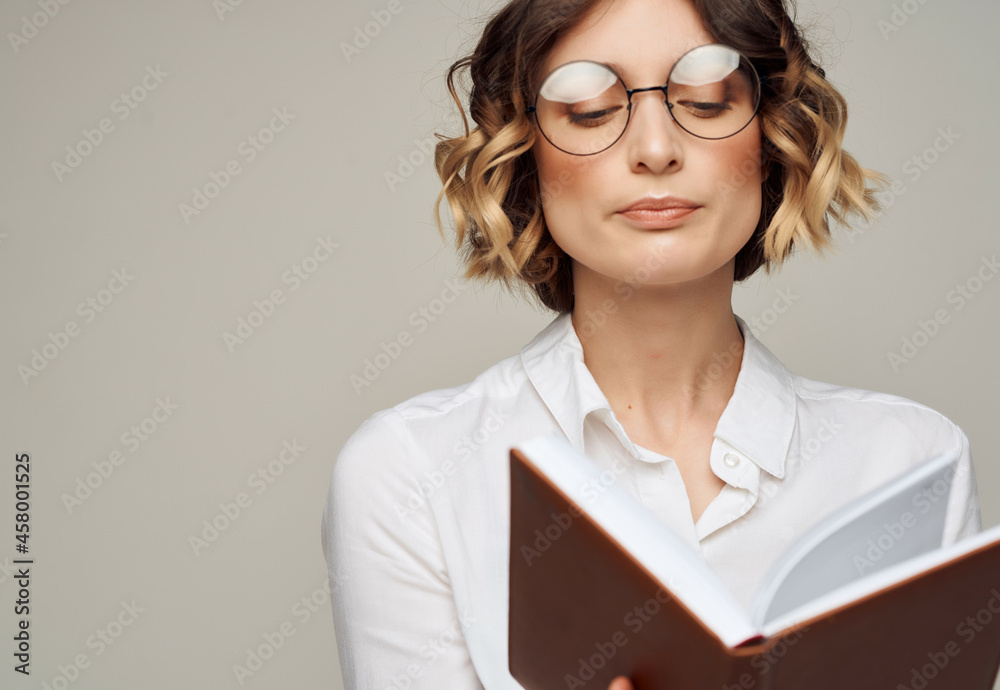 pretty woman in glasses with book elegant style for professionals Studio pretty woman in glasses with book elegant style for professionals Studio