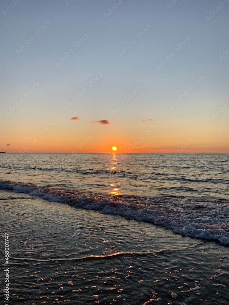 Fantastic orange and purple sunset at the sandy beach, paradise, evening sea background