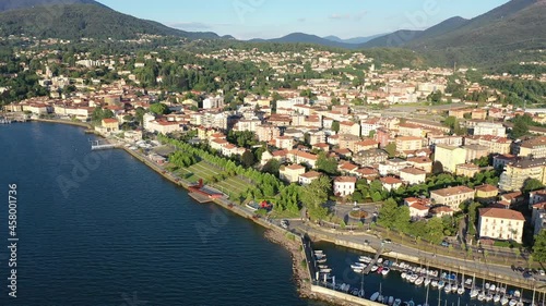 View from drone of summer Luino cityscape and Lake Maggiore, province of Varese, Lombardy, northern Italy. High quality 4k footage