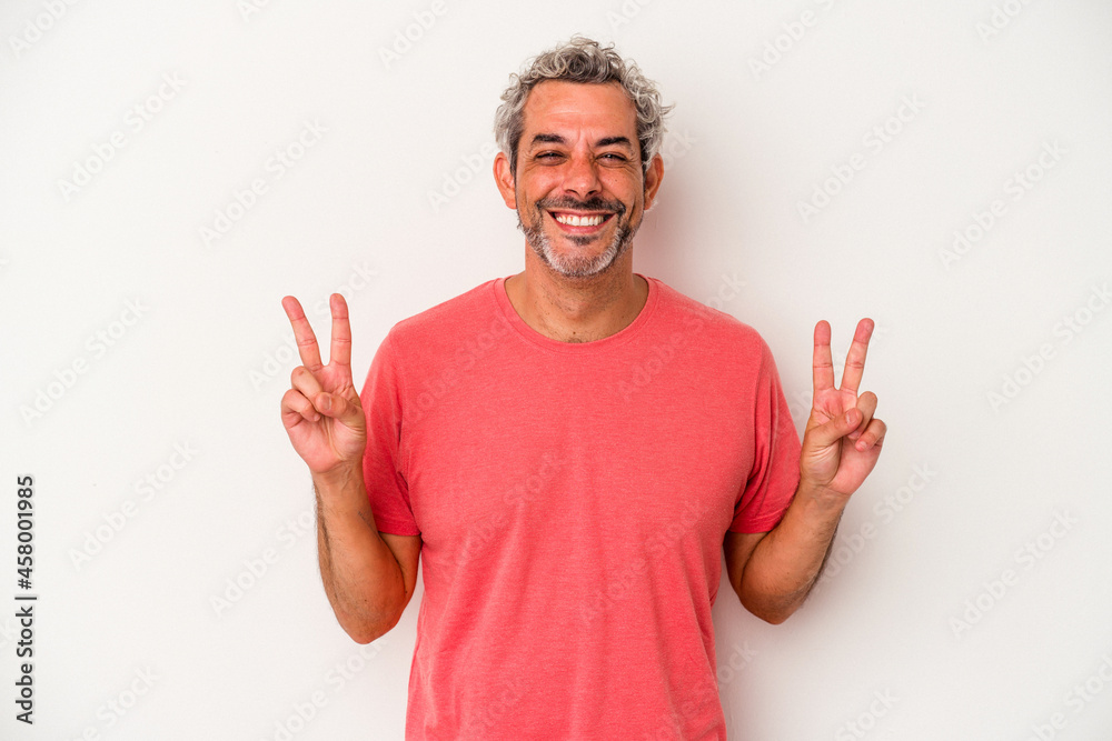 Naklejka premium Middle age caucasian man isolated on white background showing victory sign and smiling broadly.