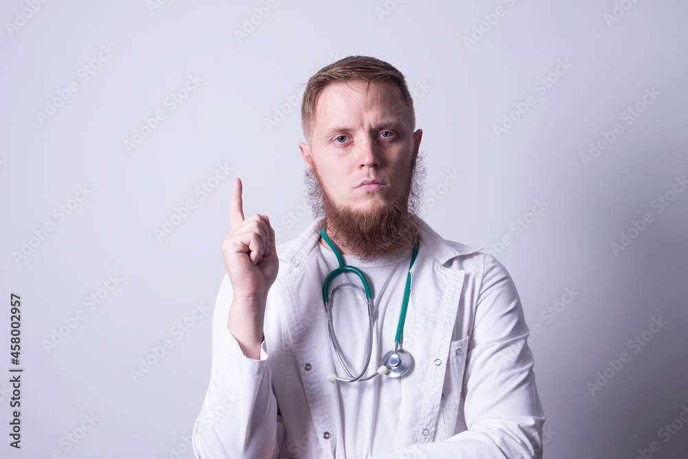 Male doctor in laboratory coat on gray background Male doctor in laboratory coat on gray background