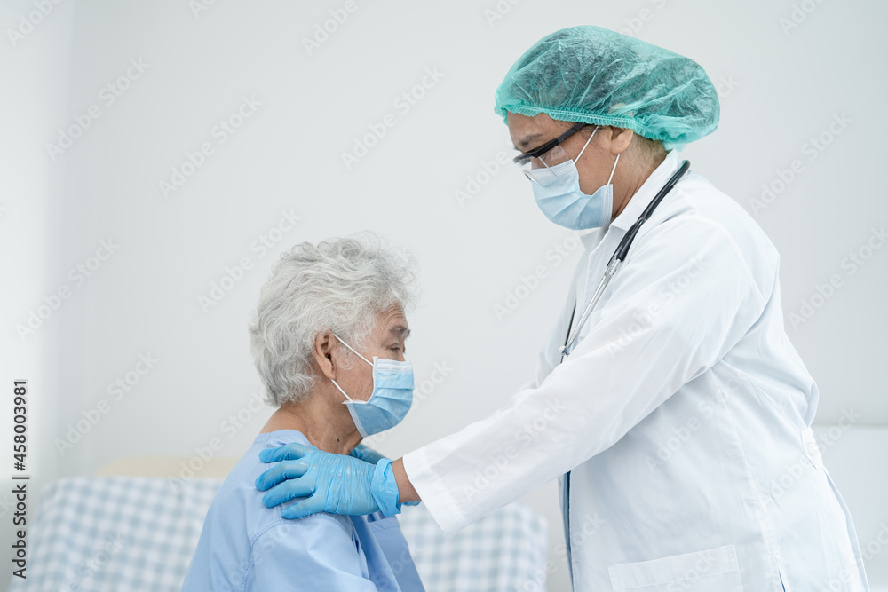 Doctor help Asian senior or elderly old lady woman patient wearing a face mask in hospital for protect safety infection and kill Covid-19 Coronavirus. Doctor help Asian senior or elderly old lady woman patient wearing a face mask in hospital for protect safety infection and kill Covid-19 Coronavirus.