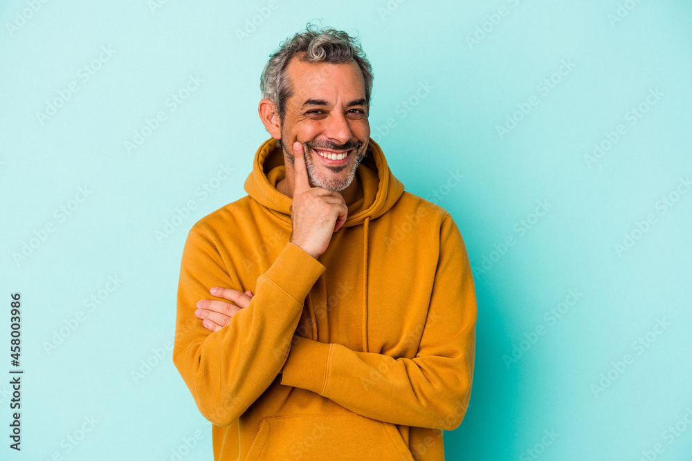 Middle age caucasian man isolated on blue background smiling happy and confident, touching chin with hand. Middle age caucasian man isolated on blue background smiling happy and confident, touching chin with hand.
