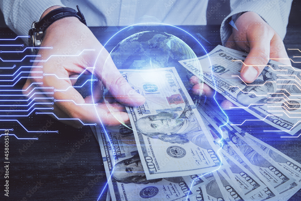 Multi exposure of brain drawing hologram and us dollars bills and man hands. Ai invest concept Multi exposure of brain drawing hologram and us dollars bills and man hands. Ai invest concept