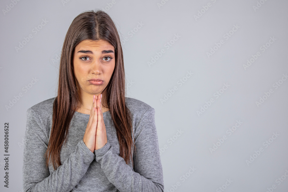 Beautiful african american woman wearing casual sweater begging and praying with hands together with hope expression on face very emotional and worried. begging.