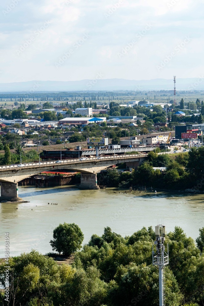 Traffic cars on emergency road bridge across Kuban River. In background is construction of new four-lane road bridge .Krasnodar, Russia - September 05, 2021