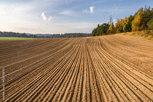 Autumn rural countryside with ruts in plowed field
