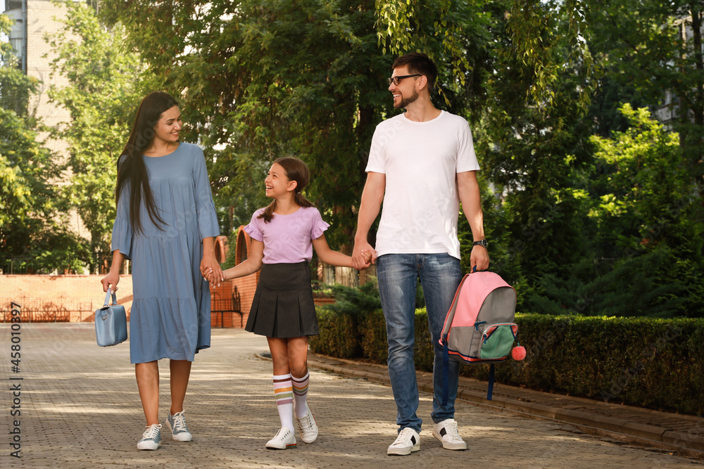 Fototapeta premium Parents taking their daughter to school in morning