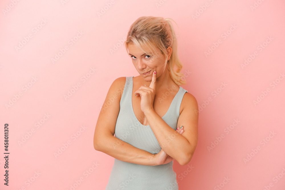 Young Russian woman isolated on pink background contemplating, planning a strategy, thinking about the way of a business. Young Russian woman isolated on pink background contemplating, planning a strategy, thinking about the way of a business.
