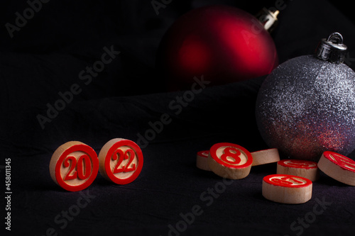 Barrels of the Lotto Board Game with Numbers 2022 years - black background and copy space