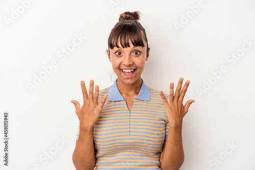 Young mixed race woman isolated on white background showing number ten with hands.