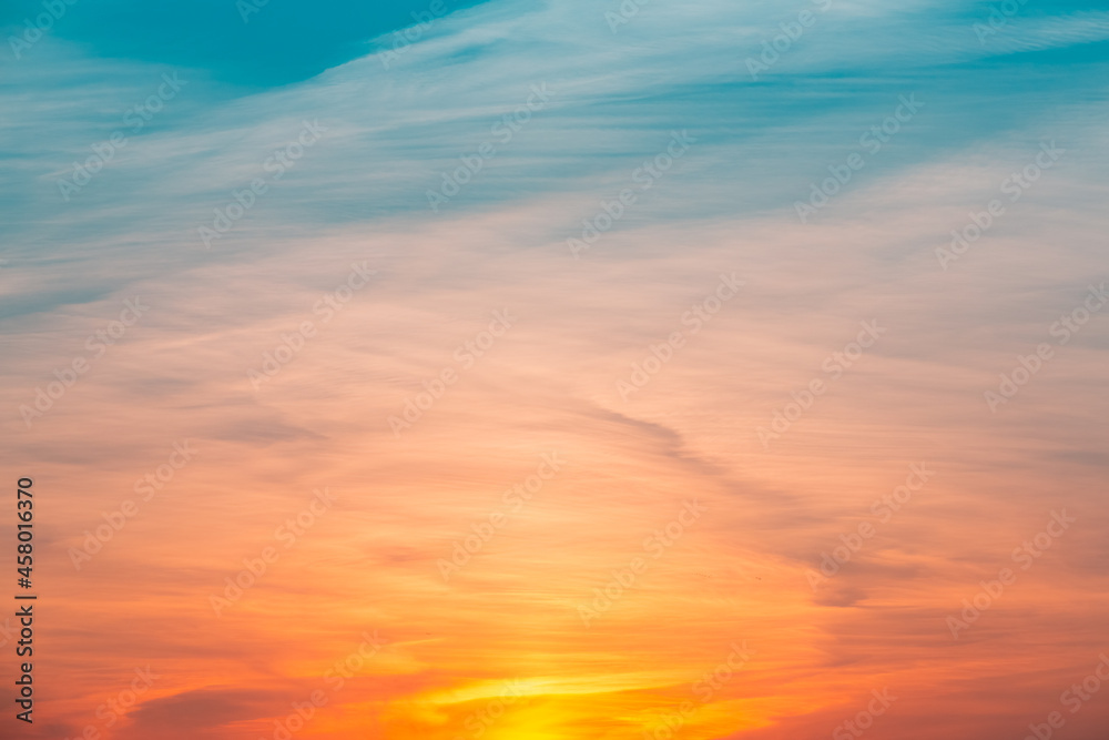 Obraz premium Pastel colored sunset sky. Abstract background with rays and lights. Stunning sunset at Gulf of Finland. Bright backlit sky and clouds. Incredible wallpaper. Blue, orange, pink backdrop