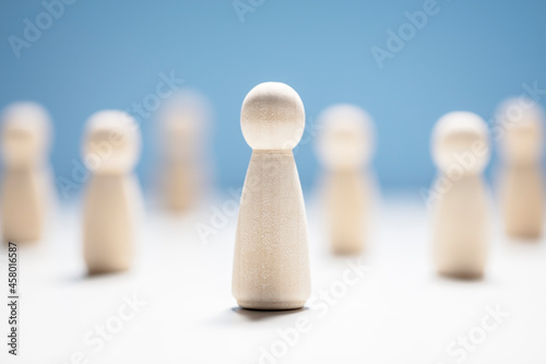 Wooden business team with one person standing out from the crowd