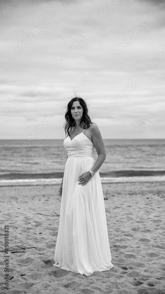 Junge schöne Braut im Hochzeitskleid am Meer Junge schöne Braut im Hochzeitskleid am Meer