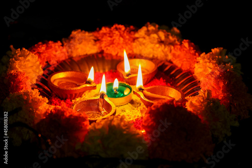 Diwali celebration Indian festival of lights Diya oil lamp and colors Rangoli decoration bright colorful  flowers flowerbed copy space greetings Dipavali Hindu festival North India Mumbai Delhi India photo