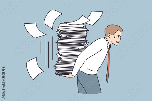 Overwork, stress, exhaustion at work concept. Young tired stressed businessman cartoon character carrying heap of papers having much duties things to do vector illustration 