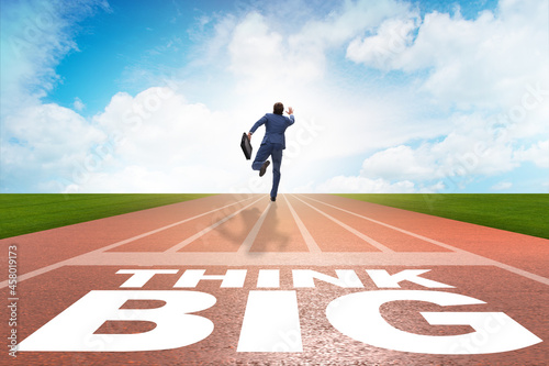Businessman in think big concept on running track