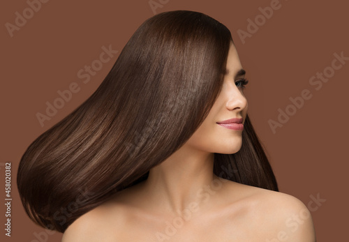 Hair Beauty Model. Brunette Woman with Long Straight Shiny Hairstyle over Dark Beige Background. Healthy Hair Care