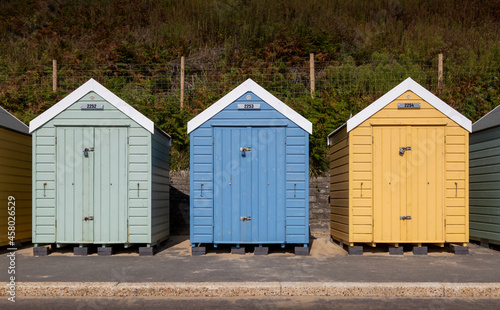 Colourful wooden beach huts © leighton collins