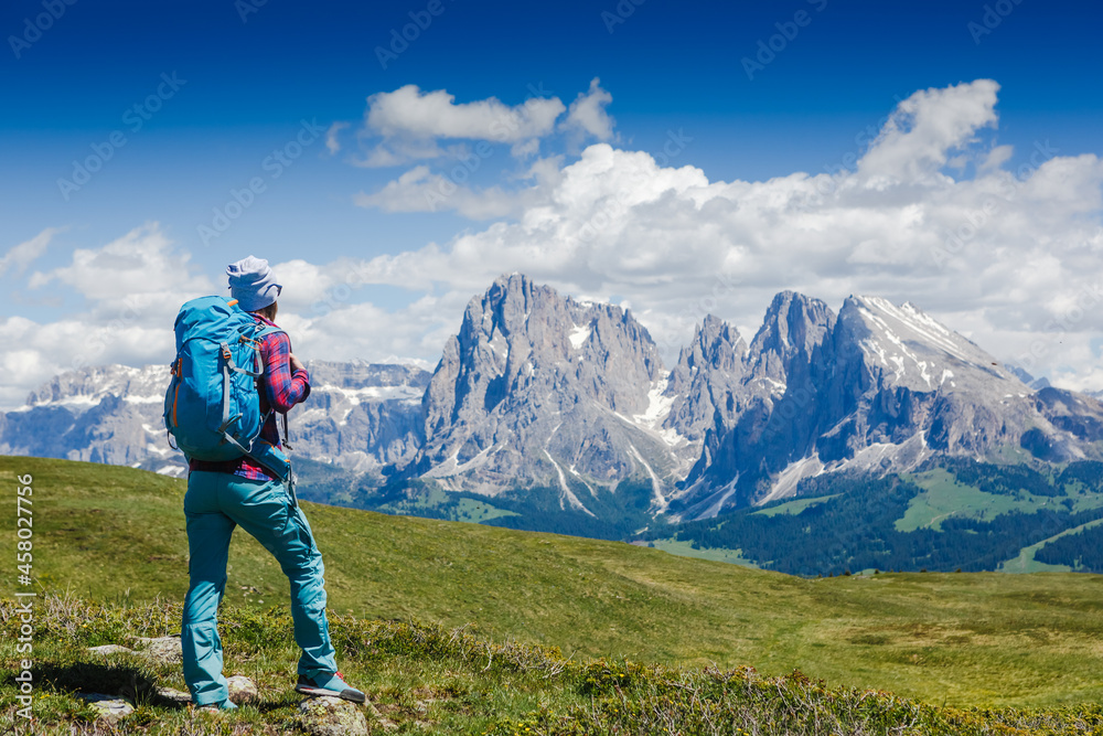 Hiker woman enjoying the views over The Dolomites in italy