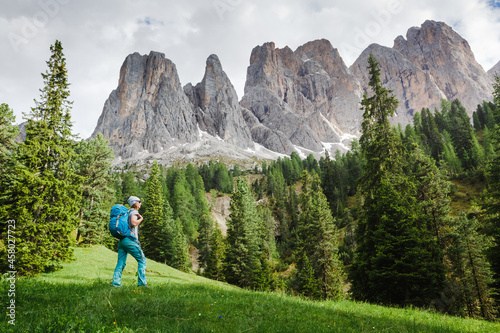 Hiker woman enjoying the views over The Dolomites in italy